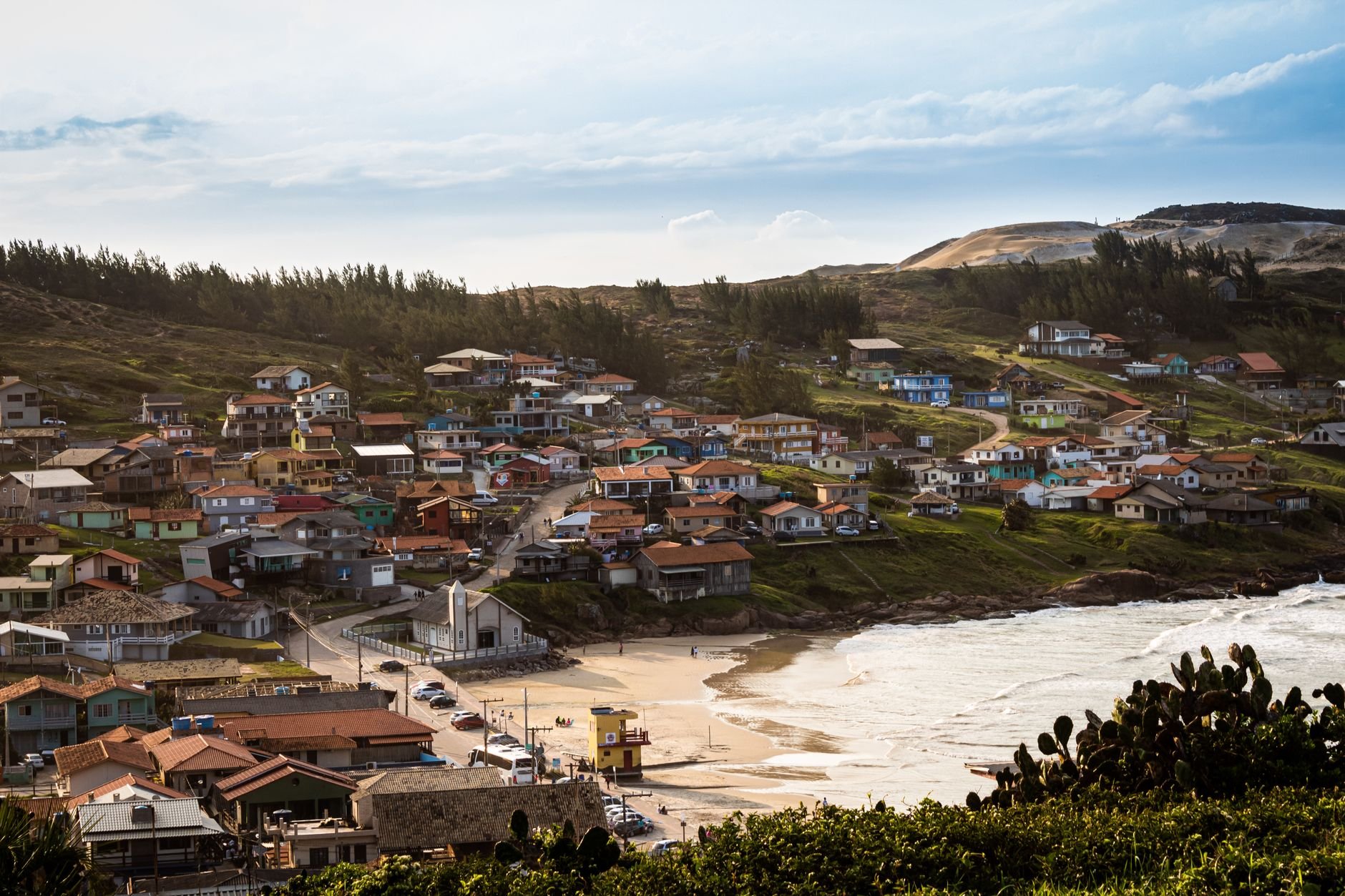 Aerial view of a picturesque coastal village showcasing colorful houses by the sea.